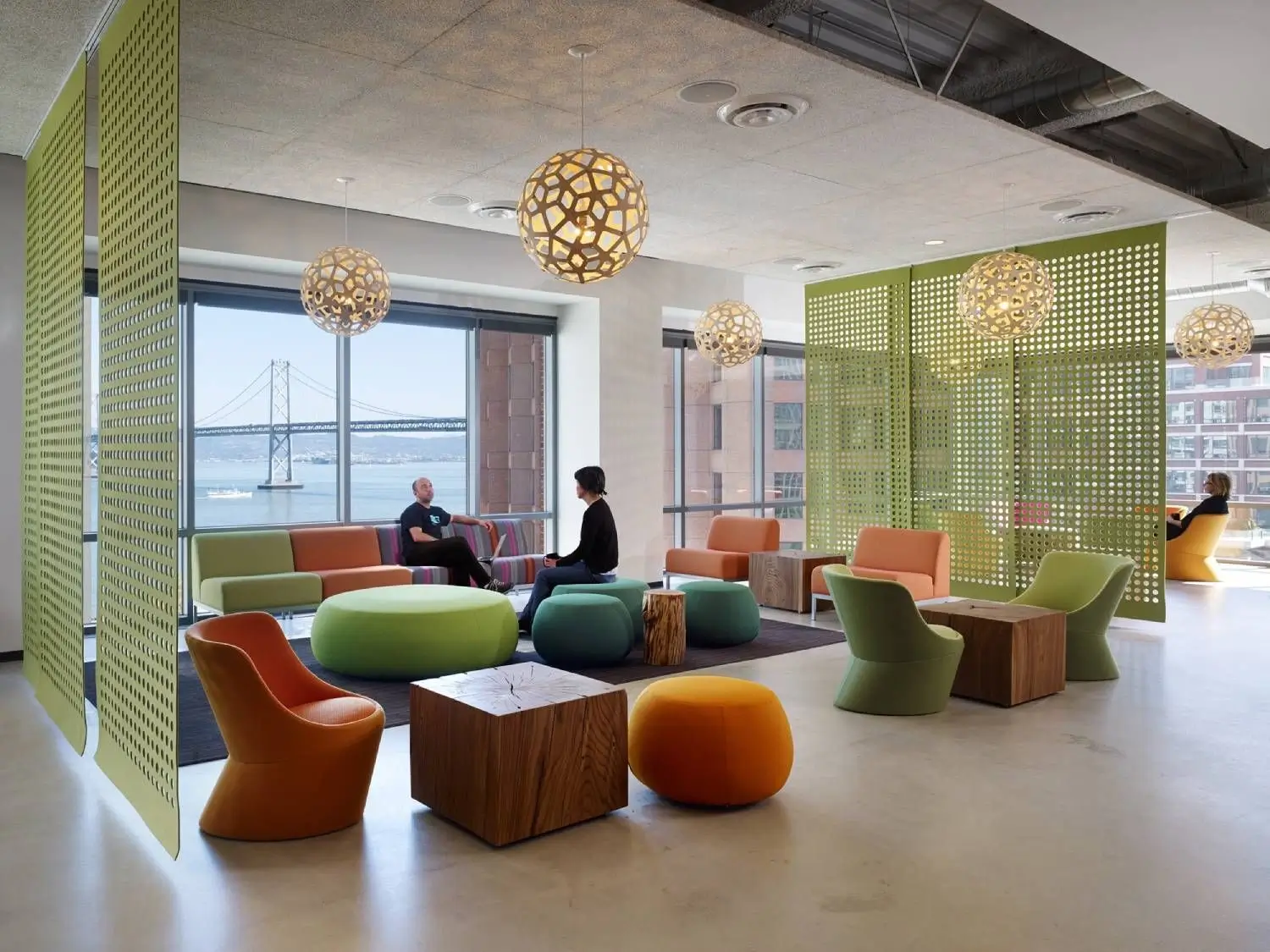 A modern hotel co-working space with comfortable seating.