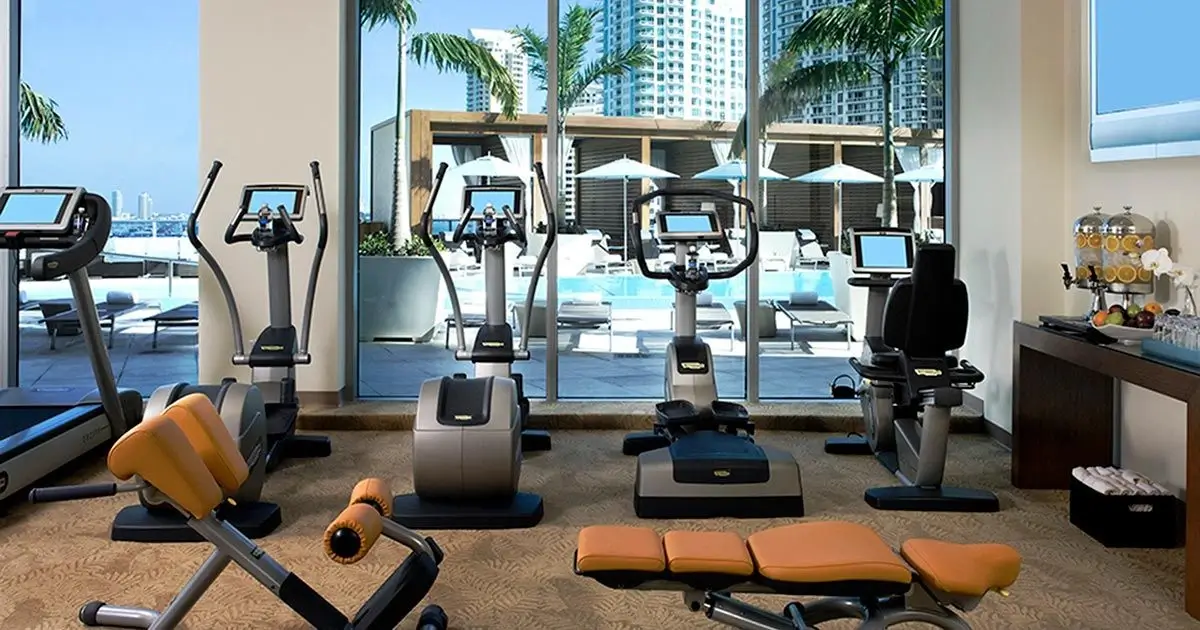 A clean and modern hotel gym with various equipment.