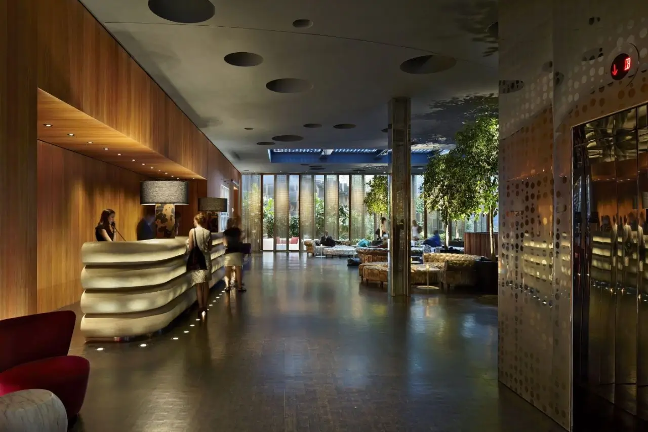 The same hotel lobby in the evening with warm, cozy lighting.