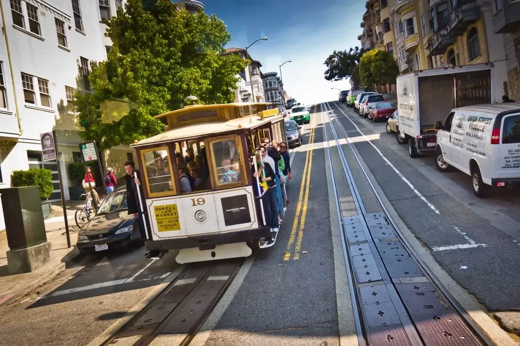 A cable car on a hill in San Francisco.